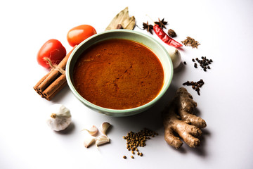 North Indian basic spicy Curry or masala for vegetables or chicken or mutton recipe shown with ingredients, served in a bowl. selective focus	homemade, restaurant, hot, oil, dark, red, indian, india, 