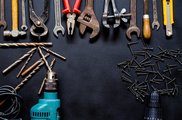 Tools for repair and reconstruction in home conditions lie on a black background