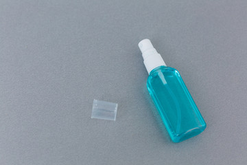 Antibacterial spray for hands antiseptic wet wipes in hands on gray background isolation