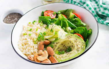 Trendy salad. Vegan Buddha bowl with bulgur, avocado, cucumber, lettuce, tomatoes and chia seeds. International Day Without Meat. Vegetarian salad.