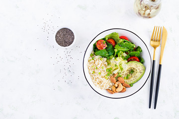Trendy salad. Vegan Buddha bowl with bulgur, avocado, cucumber, lettuce, tomatoes and chia seeds. International Day Without Meat. Vegetarian salad. Top view, overhead, flat lay