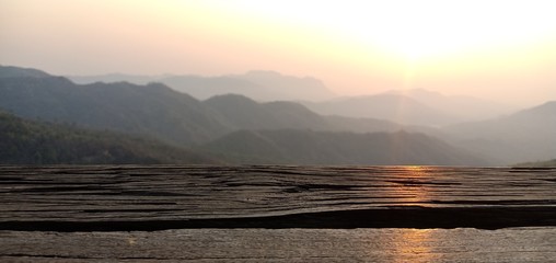 Fototapeta na wymiar Wood floor mountains and sunlight in the morning feel fresh in Thailand
