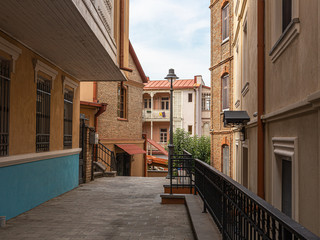 Narrow street between brick houses in old Tbilisi