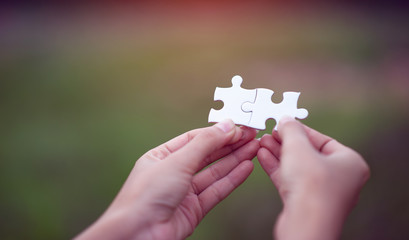 Hands and puzzles, important pieces of teamwork Teamwork concept