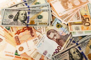 Pack of money from different countries on the table. Dollars, euros, hryvnias, Russian rubles, exchange rate. Business and finance. Currency confrontation on world market.