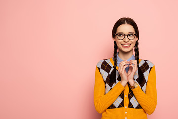 cunning female nerd in eyeglasses gesturing on pink