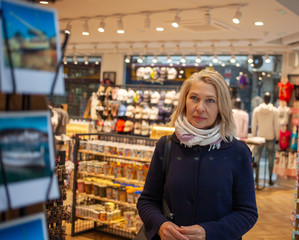 А elderly woman in a gift shop looks at cards