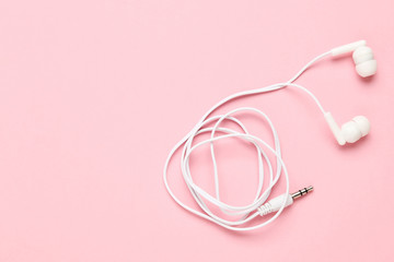 White earphones on pink background