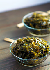 Straw seaweed. Laid out in a transparent salad bowl, on a wooden board