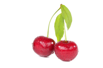 Sweet cherries with green leafs isolated on white background