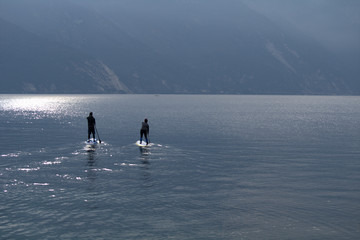 man on surfboard,water,calm,lake,landscape,nature,sport,fun,