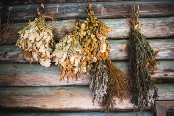 Various Dried Herbs hanging on Brown Wooden Walls