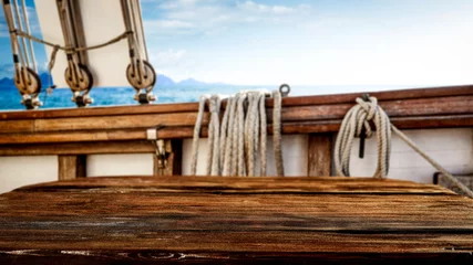  Wooden desk of free space for your decoration and blurred ship deck.Summer sea and blue sky.  © magdal3na