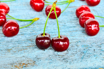 ripe sweet cherries on blue background