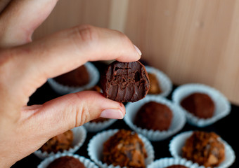 Hand holds a bitten truffle ball