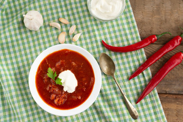Red borsch. Ukrainian food. Rustic style. Red beetroot soup with beetroot, served with sour cream and garlic.