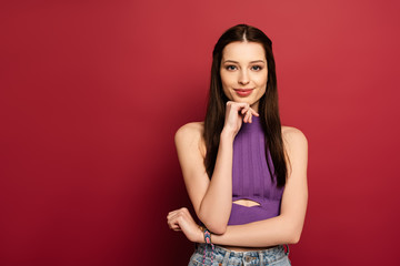 portrait of smiling brunette woman on red