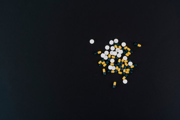 small bunch of different medicine pills flat lay on the colorful background, minimalism helthcare concept