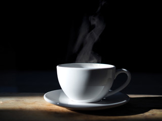 hot coffee cup and Smoke on black background