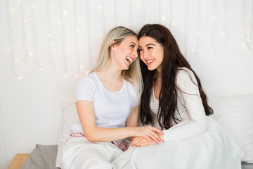 Fototapeta na wymiar two beautiful young women on the bed