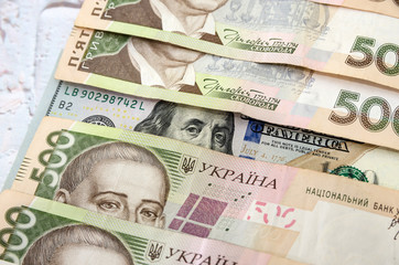 Ukrainian money - hryvnia banknotes USA dollars bills. Finance in Ukraine, of the hryvnia to the dollar exchange rate. Multi currency money dollars and hryvnia, close-up concept finance investment.