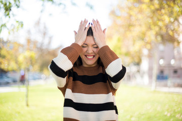 Exasperate female keeps hands on temples, feels strong headache, closes eyes with pain, need...