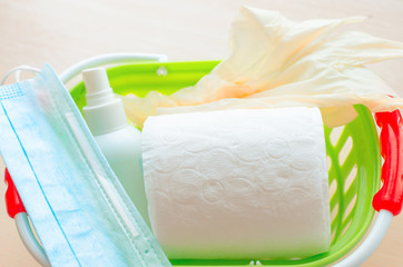 food basket with toilet paper, medical gloves, medical protective mask, buckwheat, antibacterial antiseptic, supermarket are empty shelf. A coronavirus, flu virus  outbreak, panic epidemic