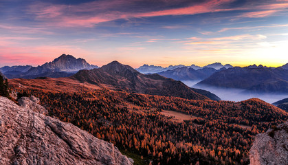 Beautiful panoramic view on Dolomites Mountains valley during sunset. Amazing nature landscape. Dolomite Alps. Italy