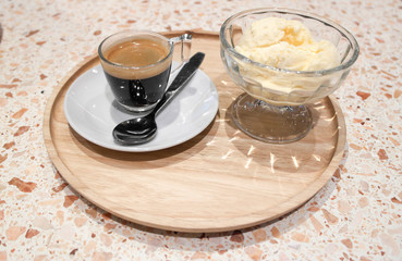 Coffee cup and ice cream vase on round dish