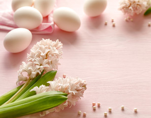 Easter pastel pink background with fresh hyacinths and eggs with copy space
