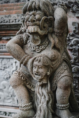 Fototapeta na wymiar Traditional demon guards statue carved in stone in Bali island