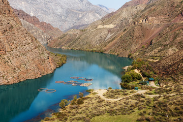 Naryn River in the Tian Shan mountains in Kyrgyzstan. fish farm on the river