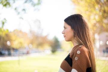 Profile of smiling woman with healthy pure skin, has contemplative expression, ready to have outdoor walk, isolated over white studio wall with copy space