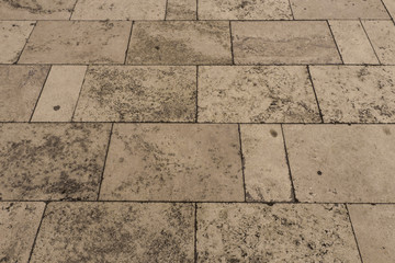 Naklejka premium Tiles on a sidewalk made of white Travertine marble 