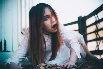 Portrait of asian woman make up ghost face with blood,Horror scene,Scary background,Halloween...