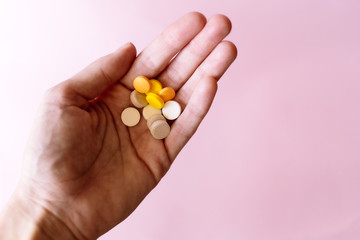 Capsules and tablets lie on the palm of your hand