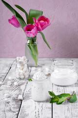 Marshmallow creme in glass jars on the white wooden table