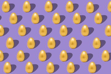 Pattern with gold eggs on purple backdrop easter background.