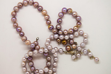 Some pearl necklaces on a white background