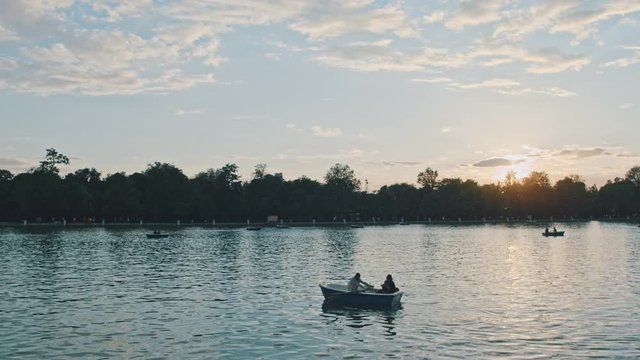 4K Madrid, Retiro Park, sunset, couple sailing on a small boat in a lake