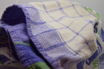 A white and blue kitchen towel - squared pattern