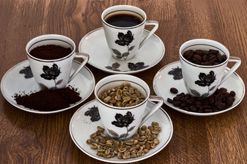 Four vintage cups of coffee with beans