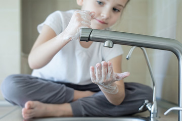 Healthy child washing hands with alcohol gel or antibacterial soap sanitizer. Hygiene concept. Prevent the spread of germs and bacteria and avoid infections corona virus. Stop coronavirus (COVID-19)