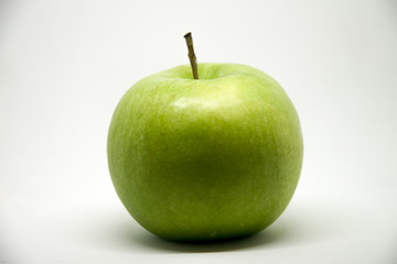 A green apple on a white background - lateral view