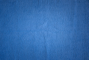 Textural background of light blue towels (rags). The center is a little lighter and darker towards...