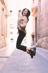 Young girl jumping on the street