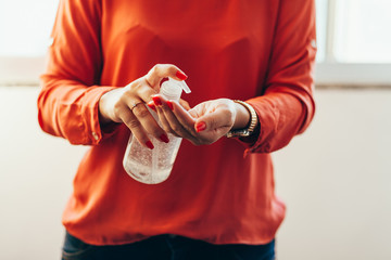 Women washing hands with alcohol gel or antibacterial soap sanitizer. Hygiene concept. Prevent the...
