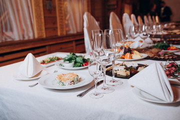 a table in the restaurant served with food and glasses