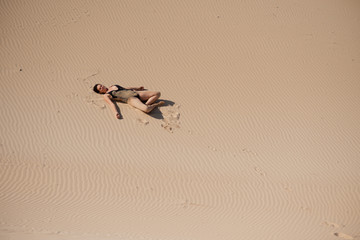 Woman laying on beach and tanning