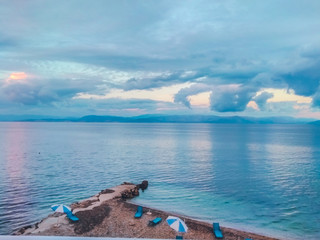 Greece, Corfu island.  A beach with crystal clear azure water and a white beach in picturesque landscapes - the paradise coastline of the island of Corfu in Paleokastritsa, Ionian archipelago